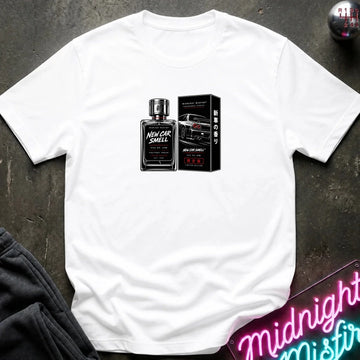 A white short-sleeve t-shirt laid flat on a dark textured surface, featuring a graphic print of a black perfume bottle and its box labeled 'New Car Smell'.