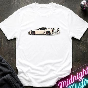 A white short-sleeve t-shirt laid flat on a dark textured surface, featuring a graphic print of a white sports car with a music note coming from exhaust.