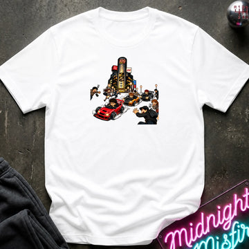 A white short-sleeve crewneck t-shirt with a graphic print of a city street scene featuring a red sports car and small figures, laid flat on a dark textured surface with a neon sign and dark pants partially visible.