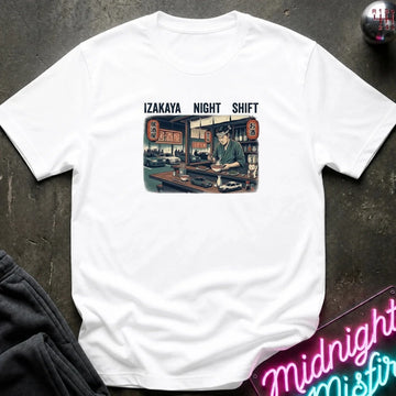 A white short-sleeve t-shirt laid flat on a dark textured surface, featuring a vintage-style graphic of an izakaya scene with the text 'IZAKAYA NIGHT SHIFT' above it. 