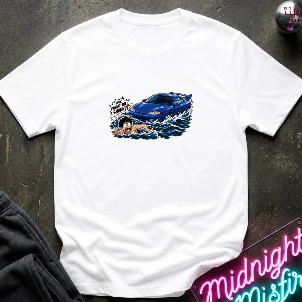 A white short-sleeved t-shirt that has a blue car chasing a swimmer in open water.