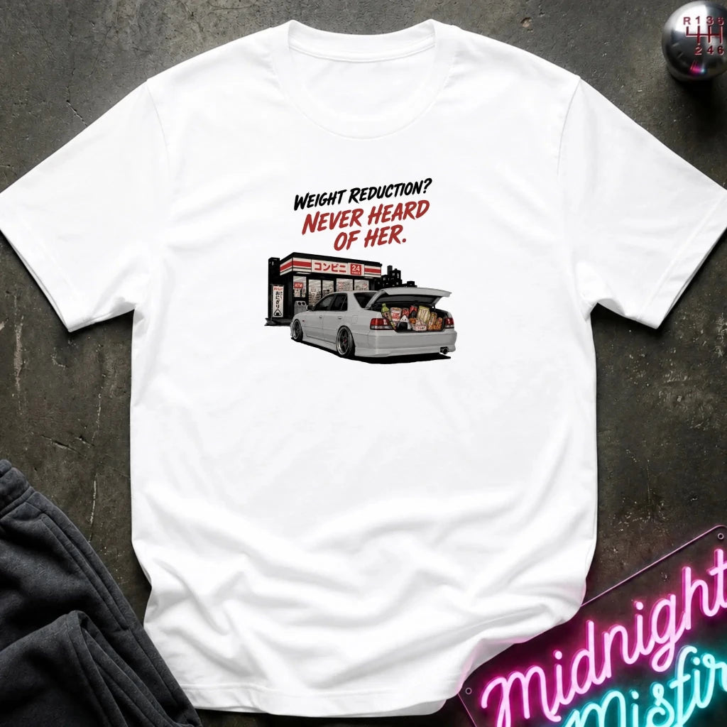 A white short-sleeve graphic t-shirt laid flat on a dark textured surface. The graphic features the text 'WEIGHT REDUCTION? NEVER HEARD OF HER.