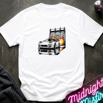 A white  short-sleeve t-shirt laid flat on a dark textured surface, featuring a graphic print of a white sports car in front of a blast off area.