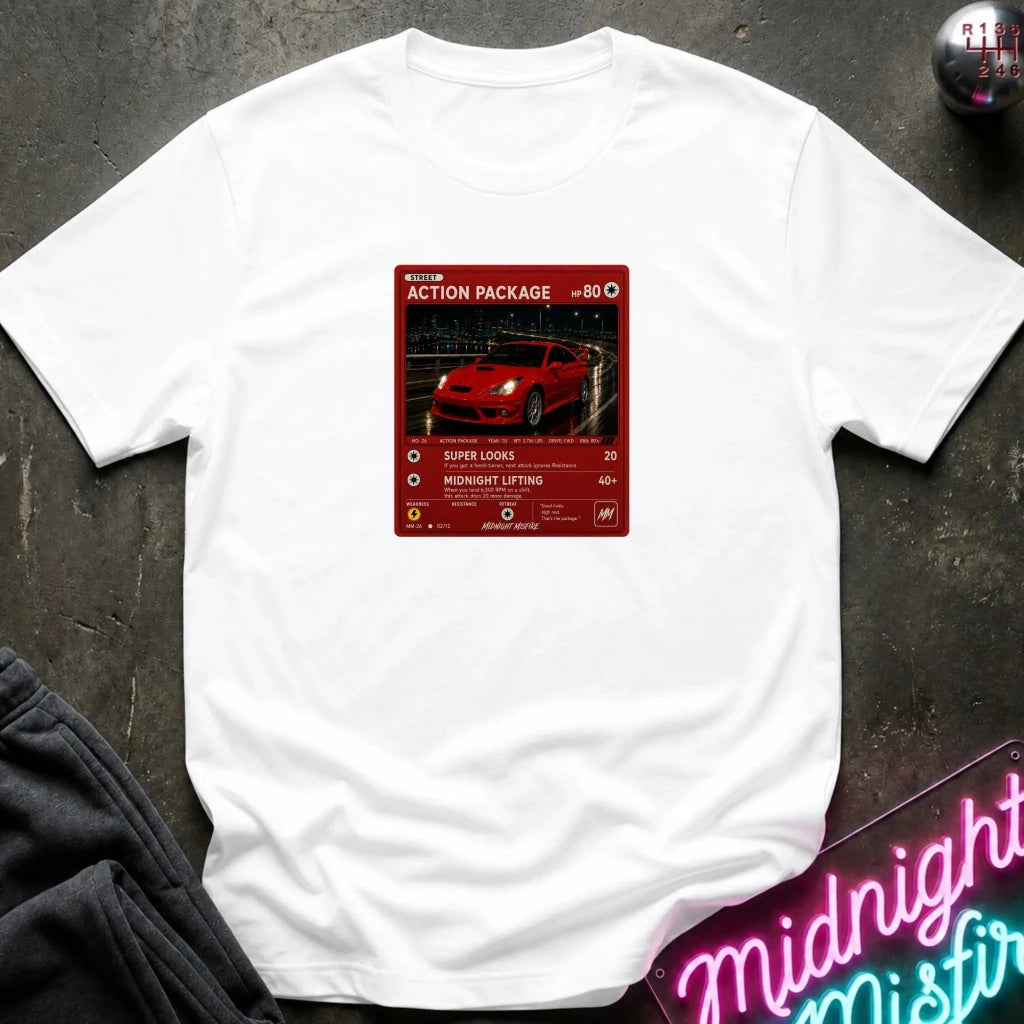 white crewneck t-shirt laid flat on a dark textured surface, featuring a red graphic print vintage card and a car.