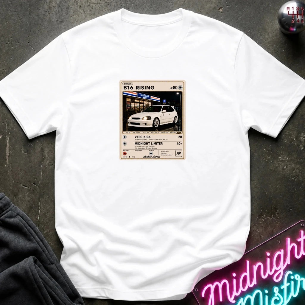 white crewneck t-shirt laid flat on a dark textured surface, featuring a graphic print of vintage card and a car.