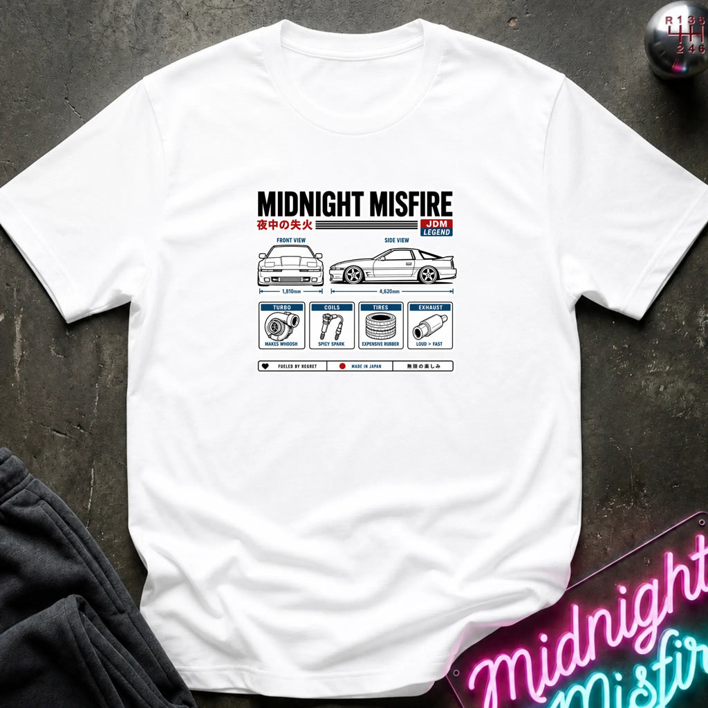 A white short-sleeve t-shirt laid flat on a dark textured surface, featuring a technical schematic graphic of car parts.