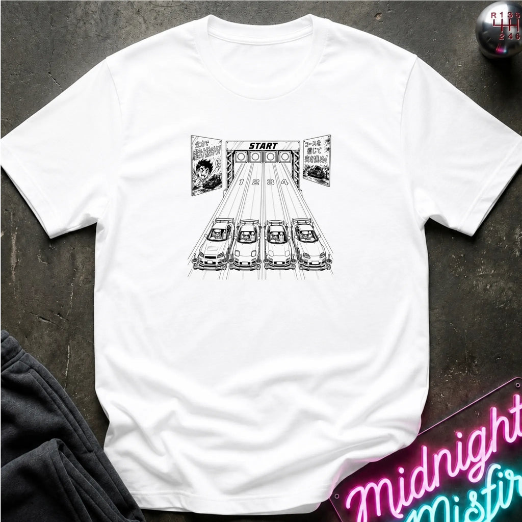 A white short-sleeve t-shirt laid flat on a dark textured surface, featuring a black-and-white graphic of 4 cars lined up at a racing on a track.