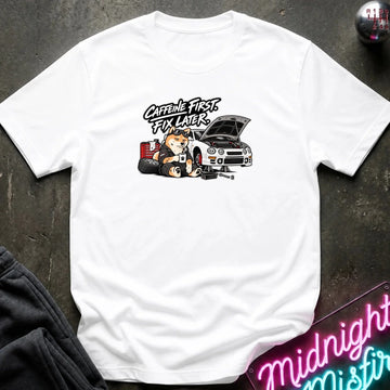 A white short-sleeve crewneck t-shirt laid flat on a dark textured surface. The shirt features a graphic print of shiba inu dog.