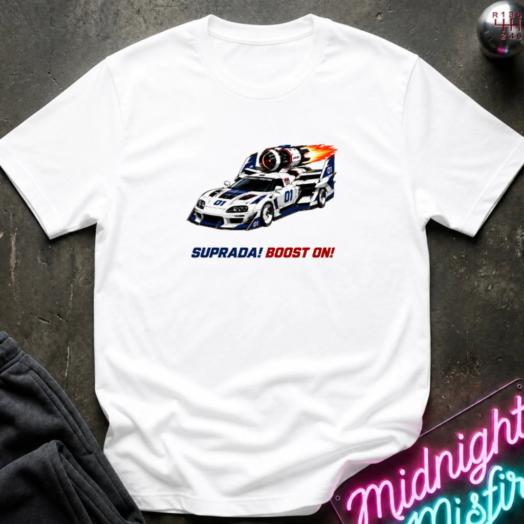 A white short-sleeve t-shirt with a retro-style graphic of a race machine with big boost, displayed flat on a dark textured surface with a neon sign and sweatpants partially visible.