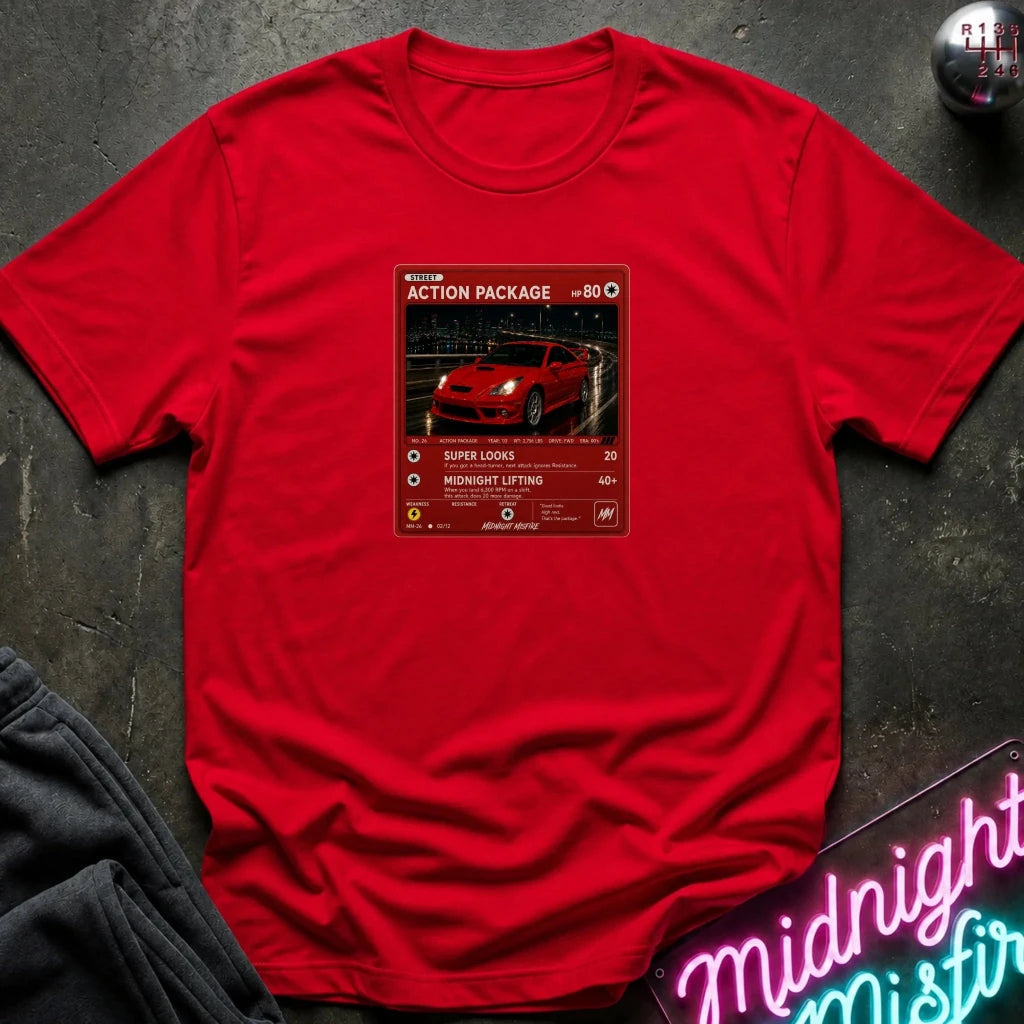 red crewneck t-shirt laid flat on a dark textured surface, featuring a red graphic print vintage card and a car.