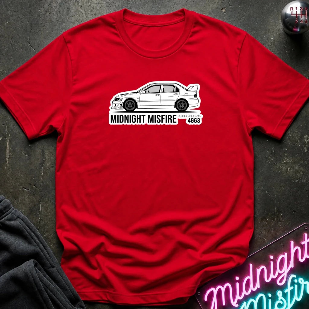 red short-sleeve t-shirt laid flat on a dark textured surface, featuring a white sports car graphic and the text 'MIDNIGHT MISFIRE '