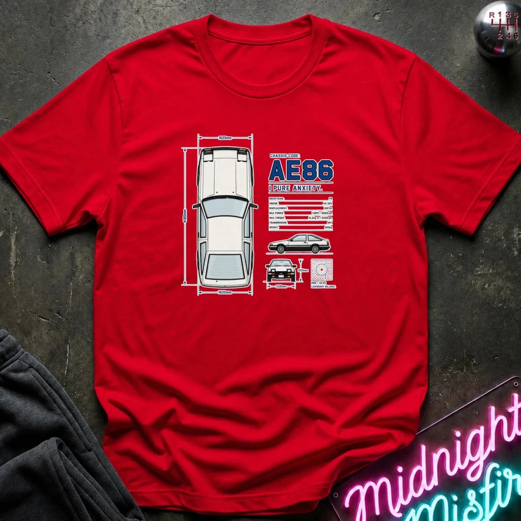 A red short-sleeve graphic T-shirt laid flat on a dark textured surface. The shirt features a printed car schematic 