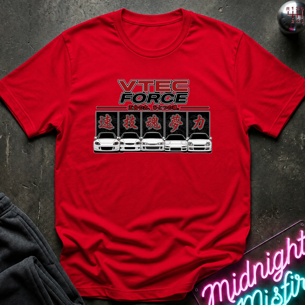 A red short-sleeve crewneck t-shirt featuring a 'VTEC FORCE' graphic with stylized car illustrations, laid flat on a dark textured surface with a neon sign and dark jacket partially visible.