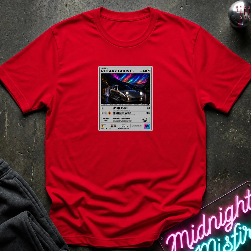red crewneck t-shirt laid flat on a dark textured surface, featuring a graphic print of vintage card and a car.