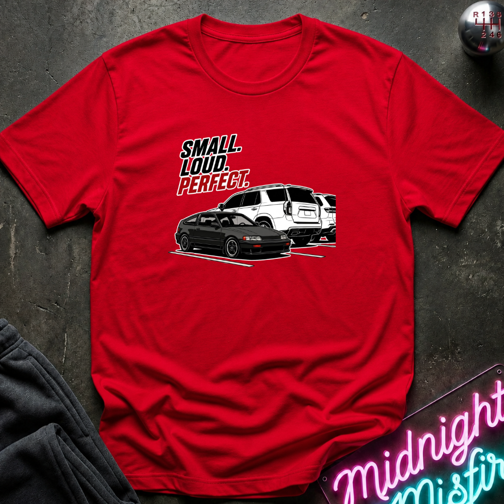 A red graphic t-shirt laid flat on a dark textured surface. The graphic features the texts.