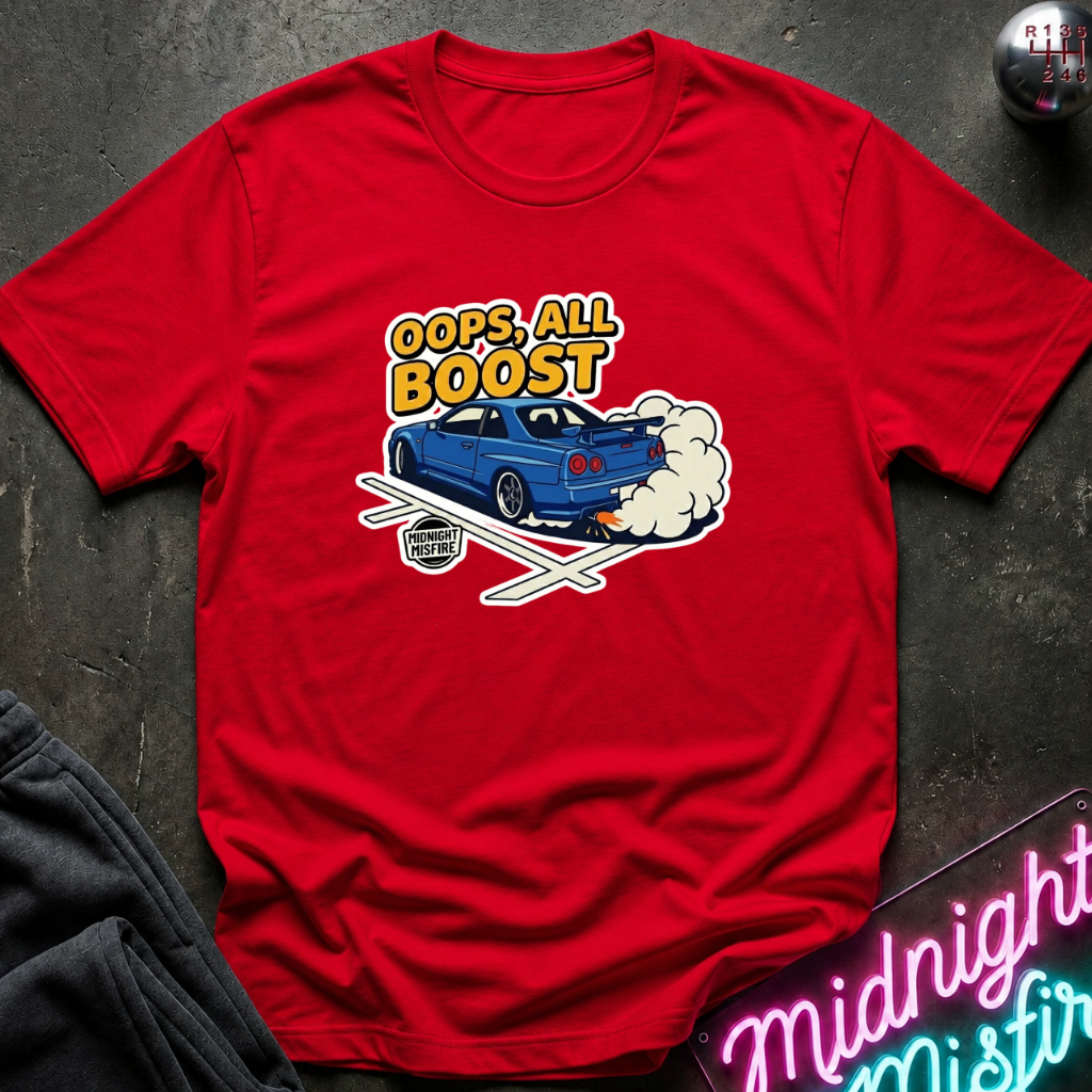 A red short-sleeve graphic t-shirt laid flat on a dark textured surface. The graphic features a blue sports car with white smoke and the text 'OOPS, ALL BOOST' in yellow and white.