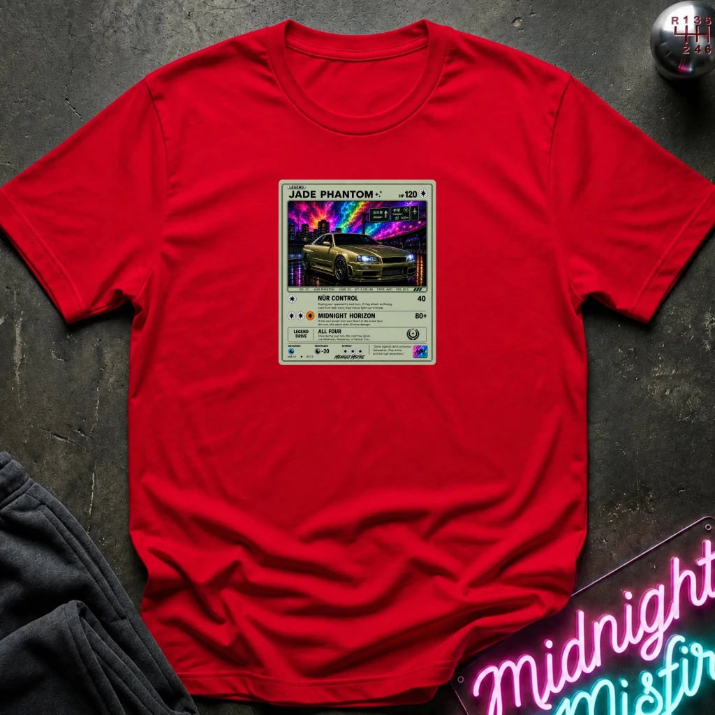 red crewneck t-shirt laid flat on a dark textured surface, featuring a graphic print of vintage card and a car.
