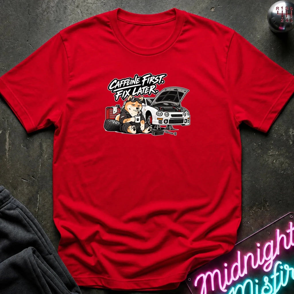 red short-sleeve crewneck t-shirt laid flat on a dark textured surface. The shirt features a graphic print of shiba inu dog.