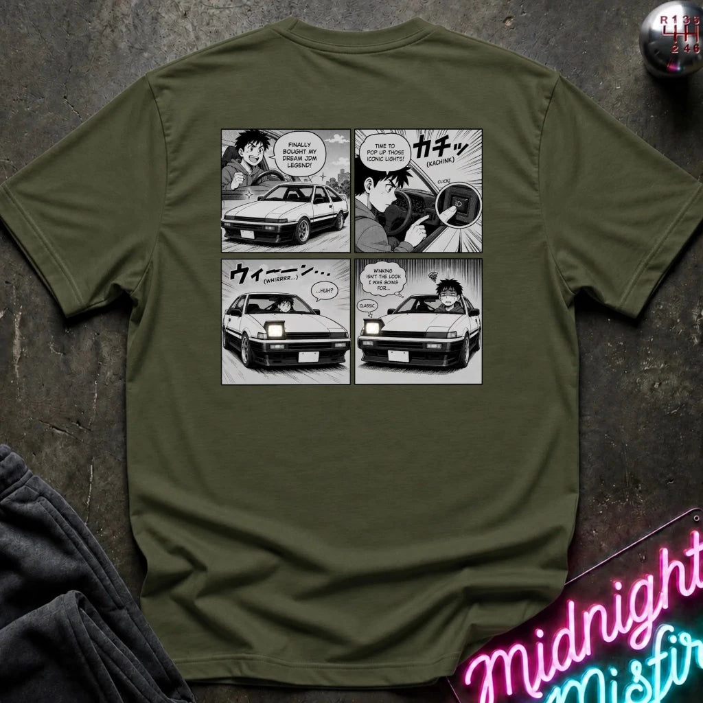 An olive green short-sleeve graphic t-shirt featuring a black and white manga comic print showing the headlight winking.