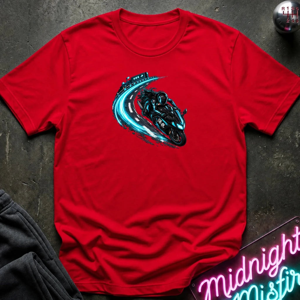 A red short-sleeve crewneck t-shirt laid flat on a dark textured surface, featuring a graphic of a black motorcycle with a glowing blue and teal trail effect. 
