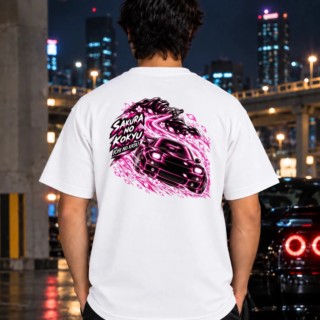 man wearing a white t-shiort showing the back graphic with a car and the text "ichi no kata!"