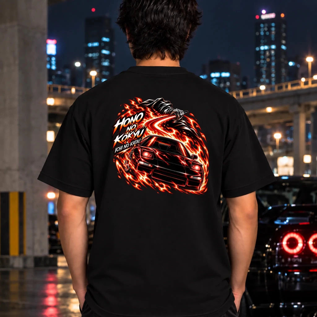 man wearing a black t-shirt showing the back graphic with a car and the text "ichi no kata!"