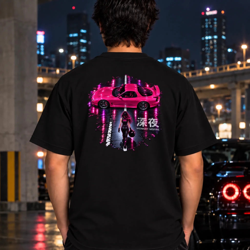 man wearing a black t-shit featuring a large rectangular graphic print on the back with a pink sports car and a woman walking under neon pink reflections.