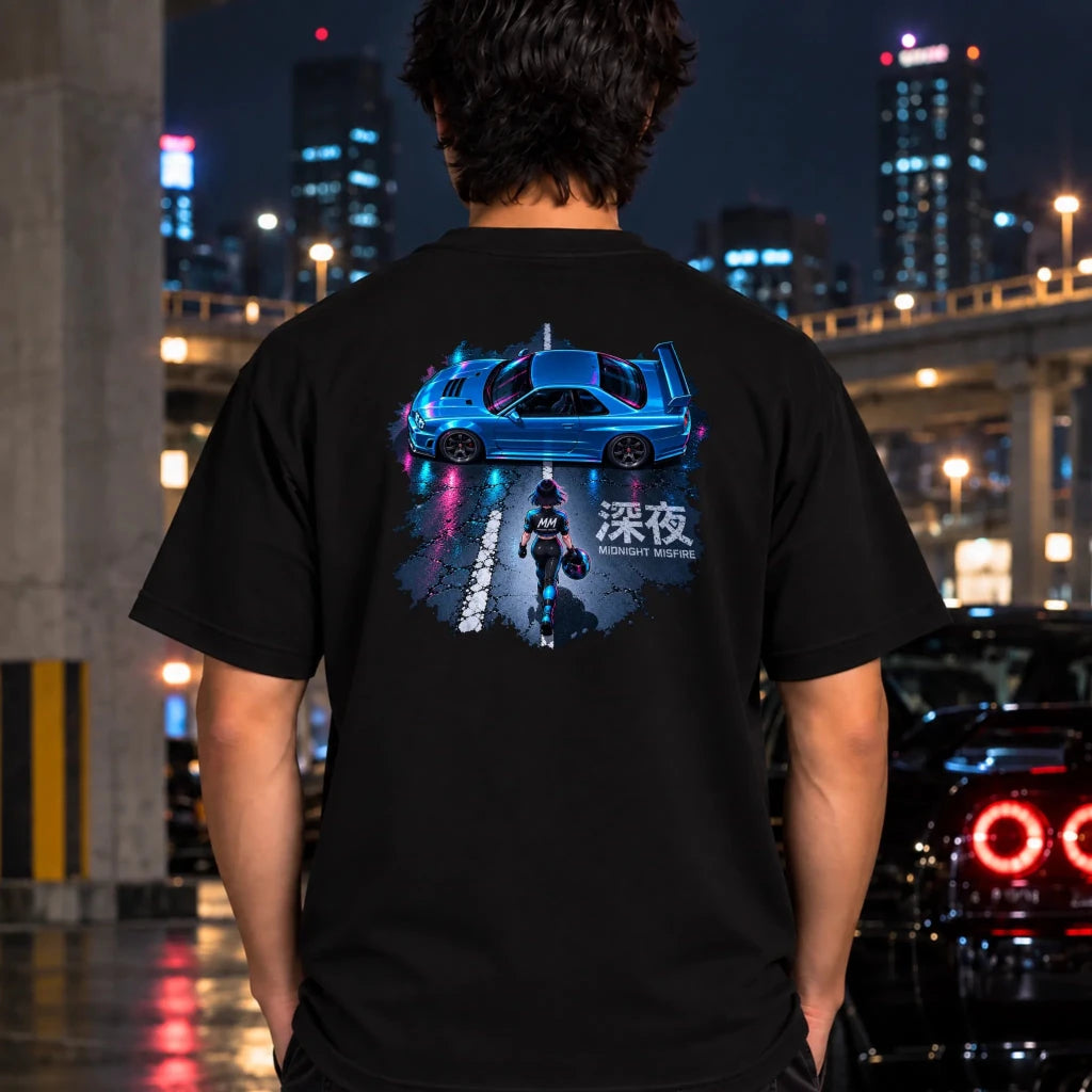 man wearing a black t-shirt featuring a large graphic print on the chest of a blue sports car on a wet street at night with neon reflections and a figure walking in the middle.