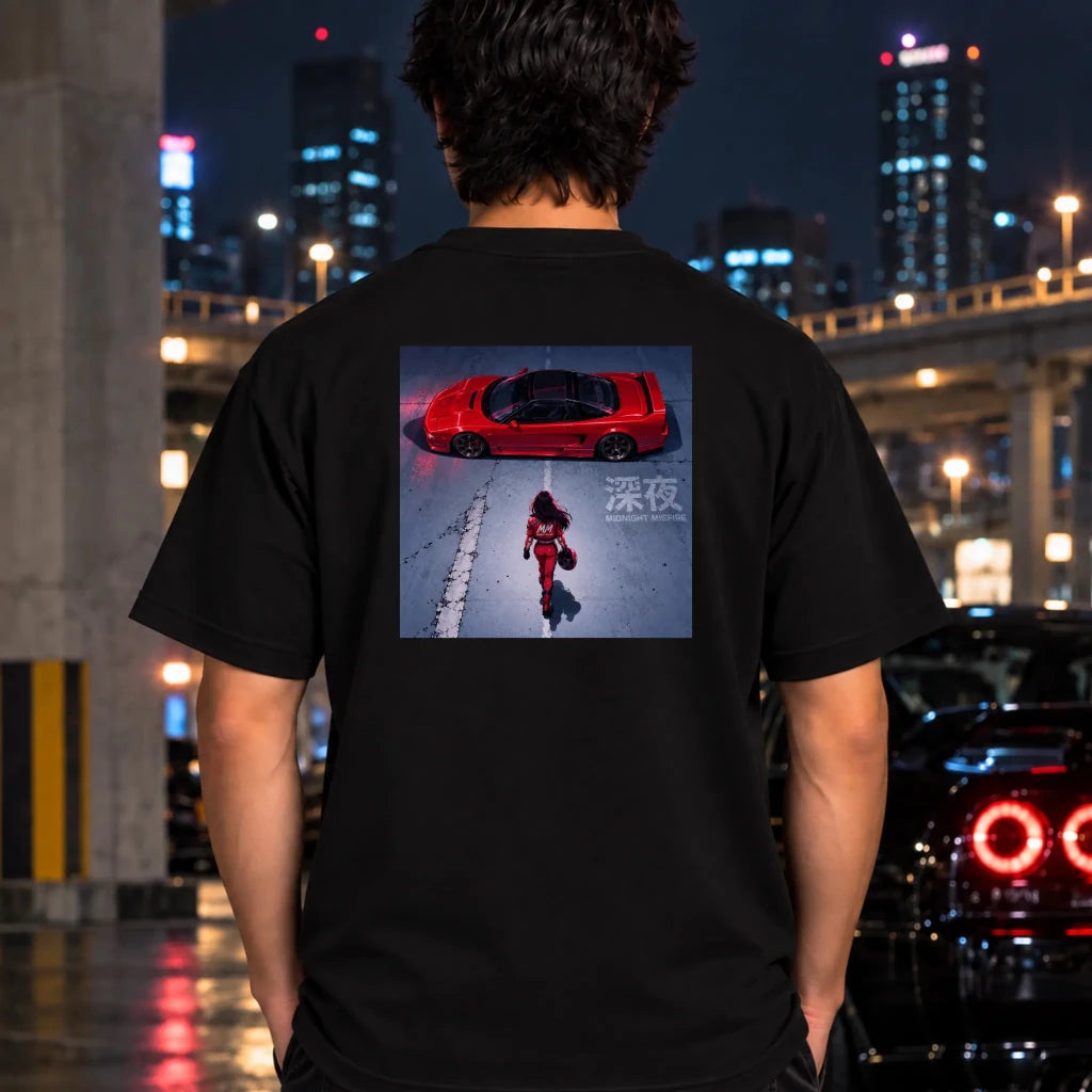 man wearing a black t-shirt featuring a square graphic print on the chest depicting a red sports car and a person in a red outfit in snow.