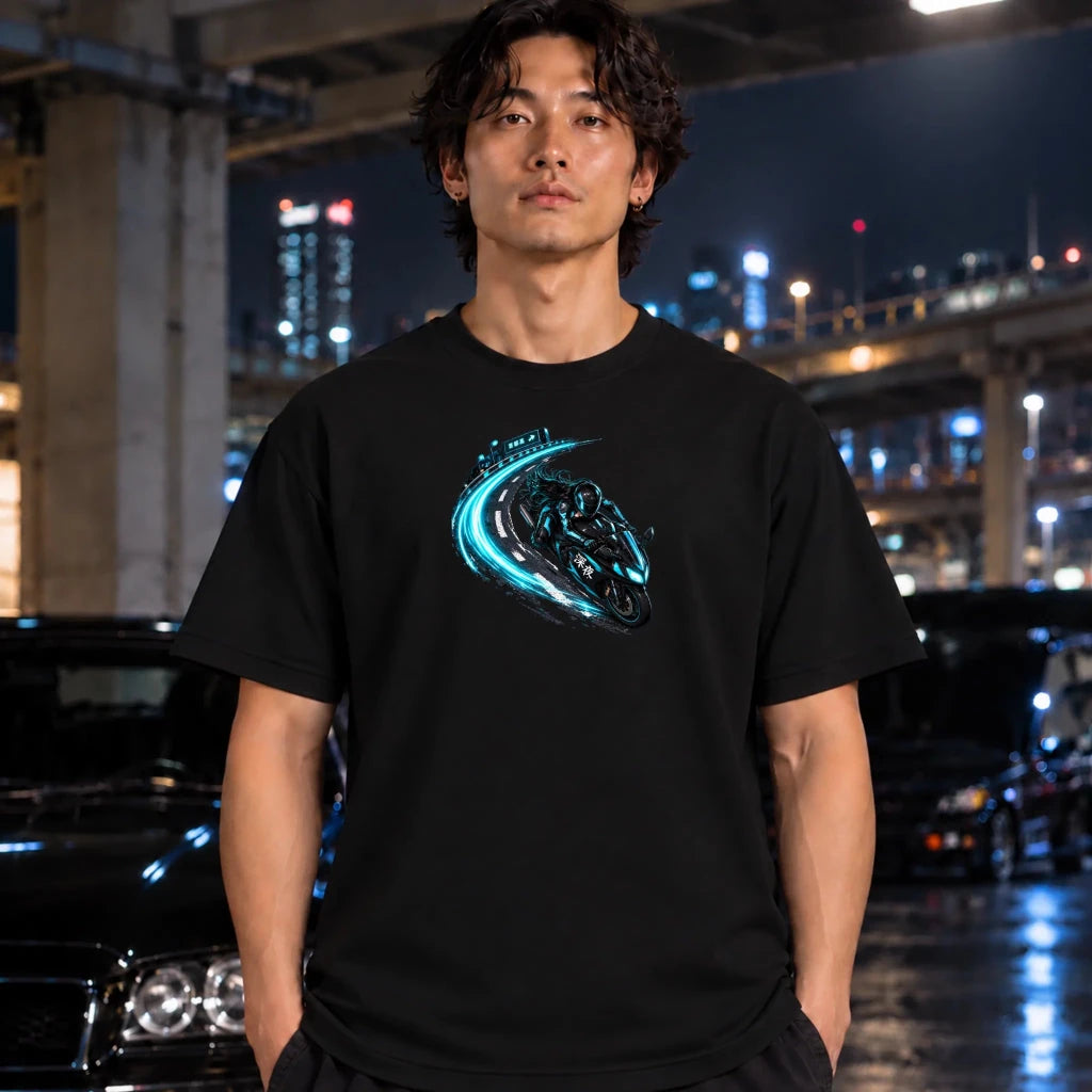 black short-sleeve t-shirt with a graphic of a black motorcycle drifting on a blue-tinted road, laid flat on a man standing under the bypass