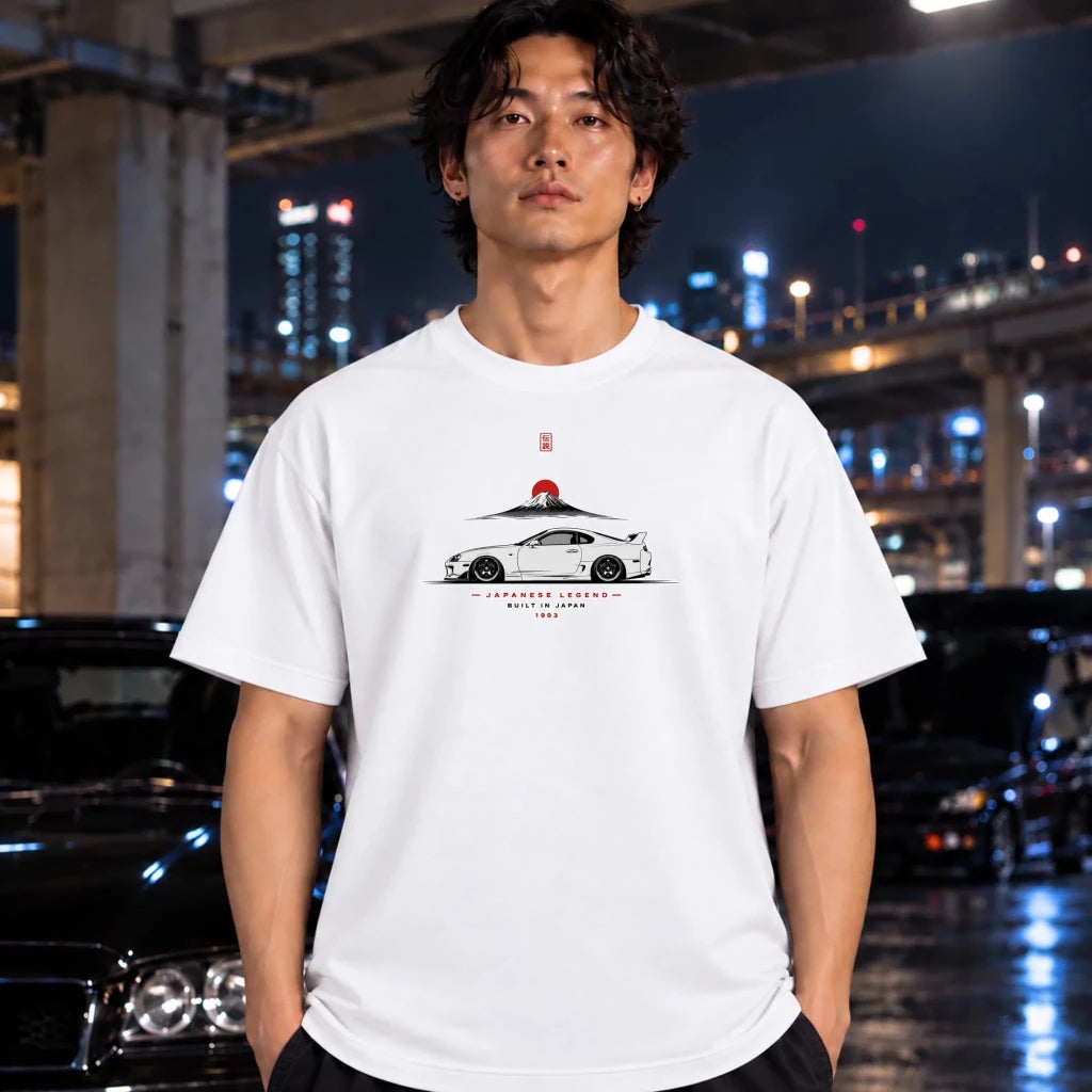 white short-sleeve t-shirt worn by a man, featuring a white and red graphic of a sports car with a mountain and Japanese sungon the chest.