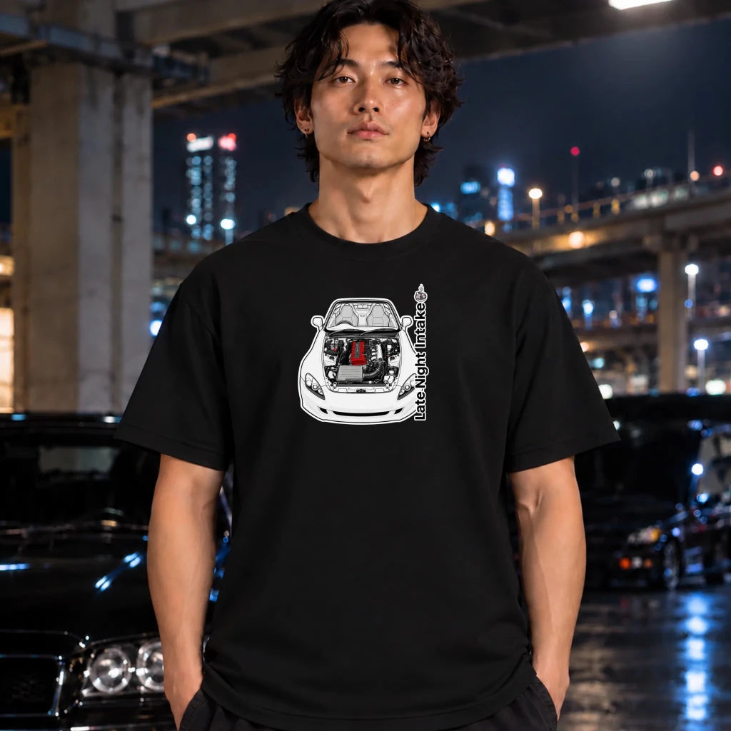 black crewneck t-shirt worn by a man, featuring a graphic of a white sports car with its hood open, revealing a red engine block. The text 'late night intake' is printed vertically next to the car.