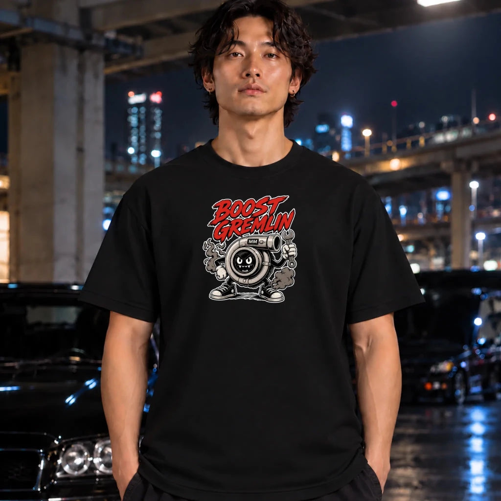 crewneck t-shirt featuring a cartoon graphic of a character with the text 'BOOST GREMLIN' in red and white, styled worn by a man