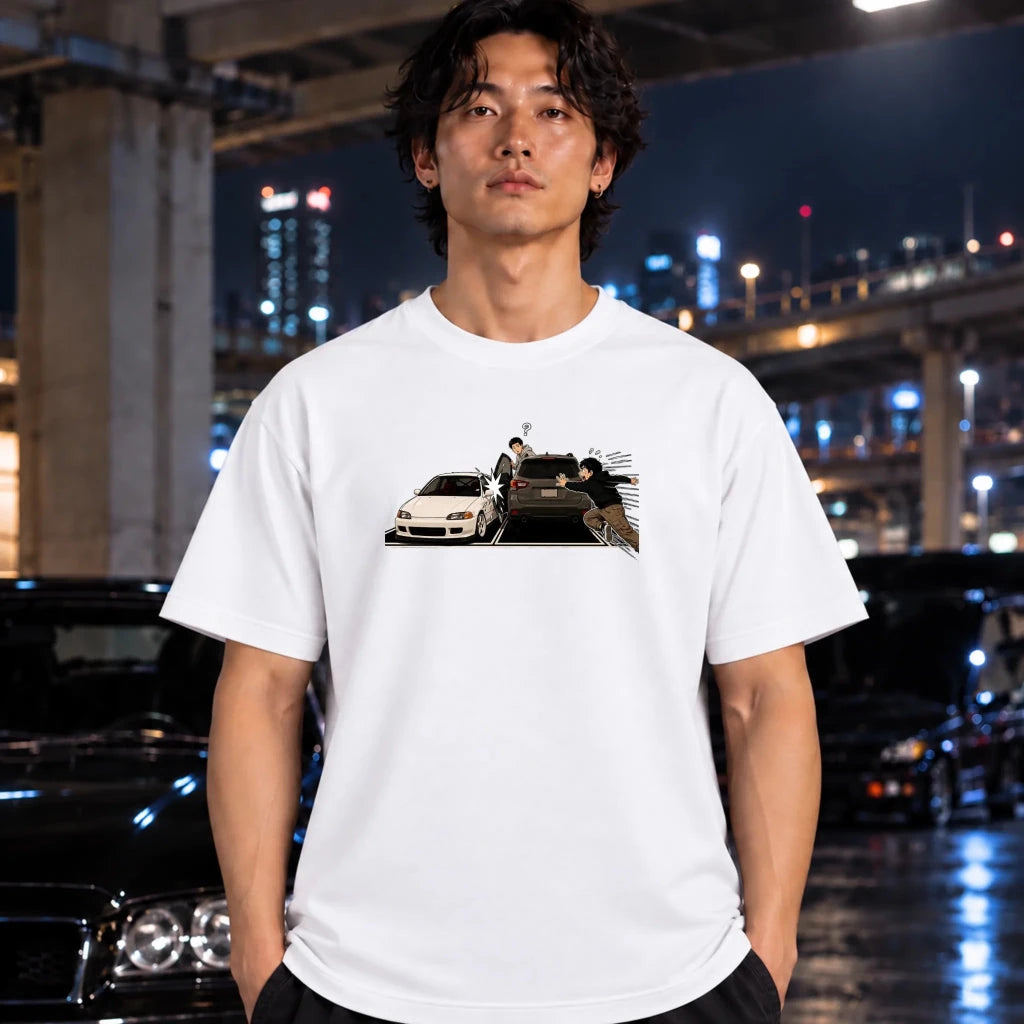 A man wearing a white short-sleeve t-shirt with a graphic print of a white sports car on a bridge at night, standing in front of a blurred city bridge background.