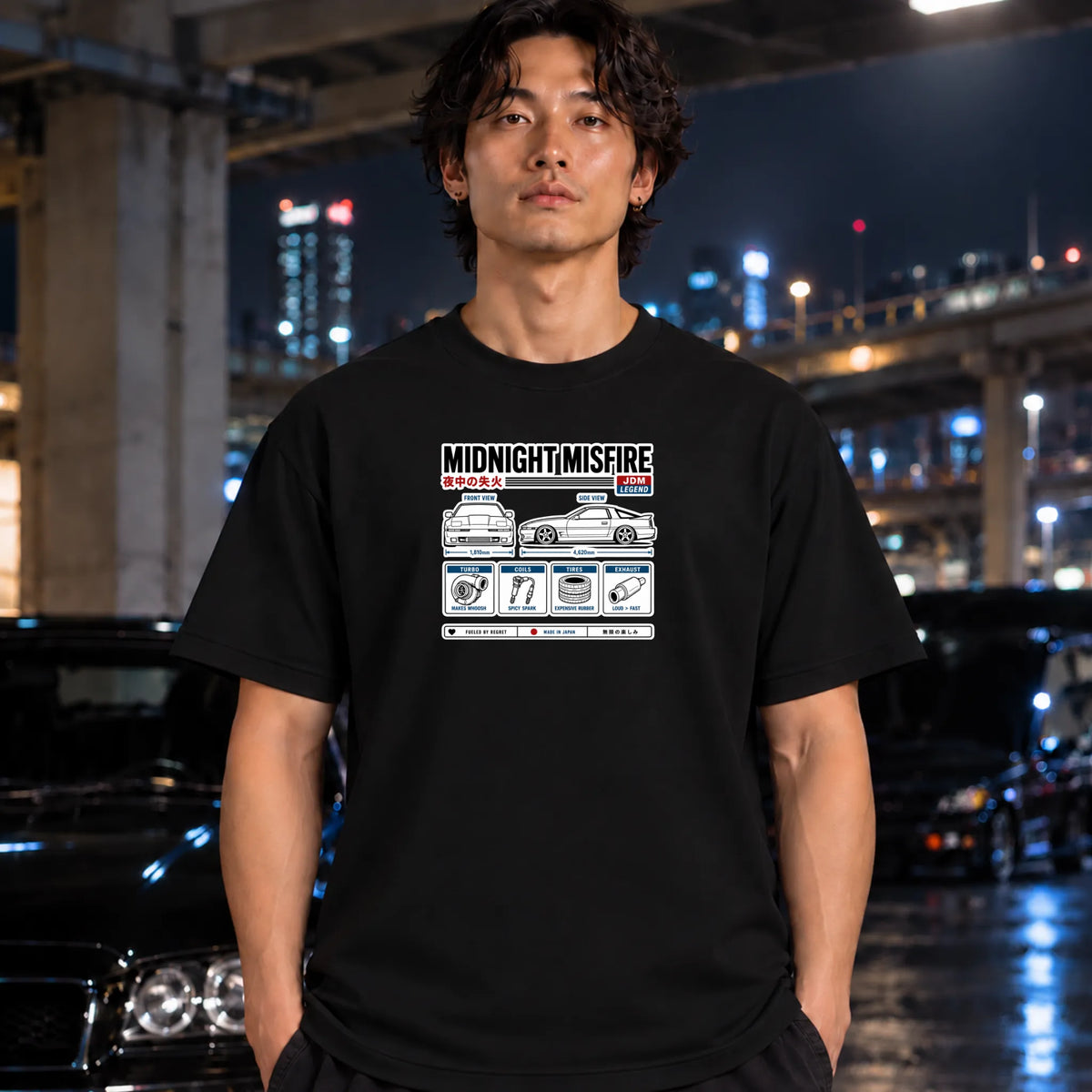 man wearing a black short-sleeve t-shirt with a white and black graphic print titled 'MIDNIGHT/MISFIRE' featuring a car diagram and Japanese text, 