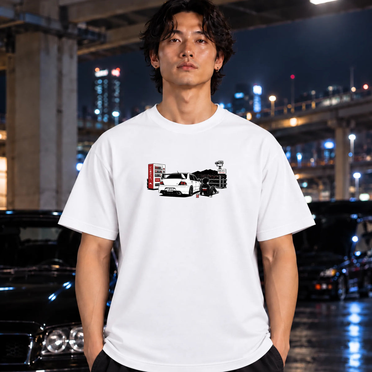 A white short-sleeve t-shirt worn by a man, featuring a graphic print of a white sports car with a red vending machine.