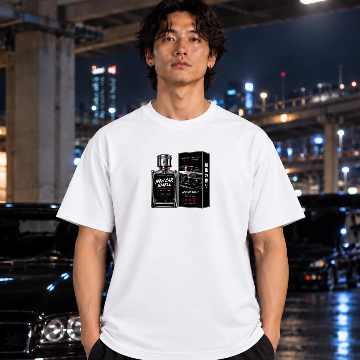 man wearing a white t-shirt featuring a graphic print of a perfume bottle and its box labeled 'New Car Smell' with a sports car illustration.