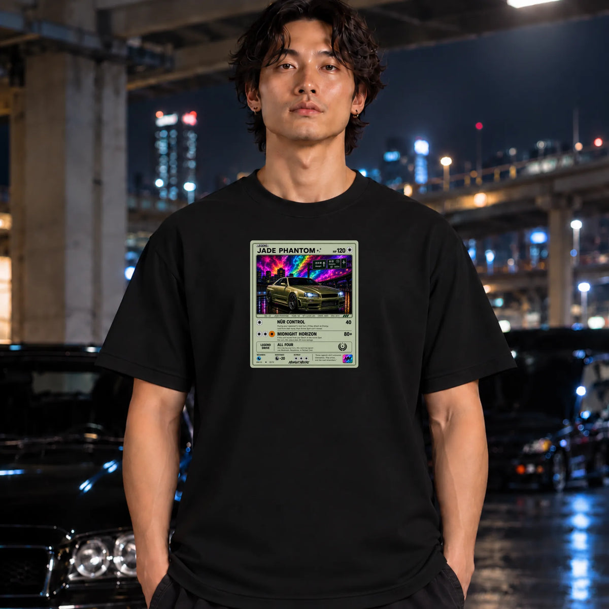 Black crewneck t-shirt worn by a man, featuring a graphic print of vintage card and a car.