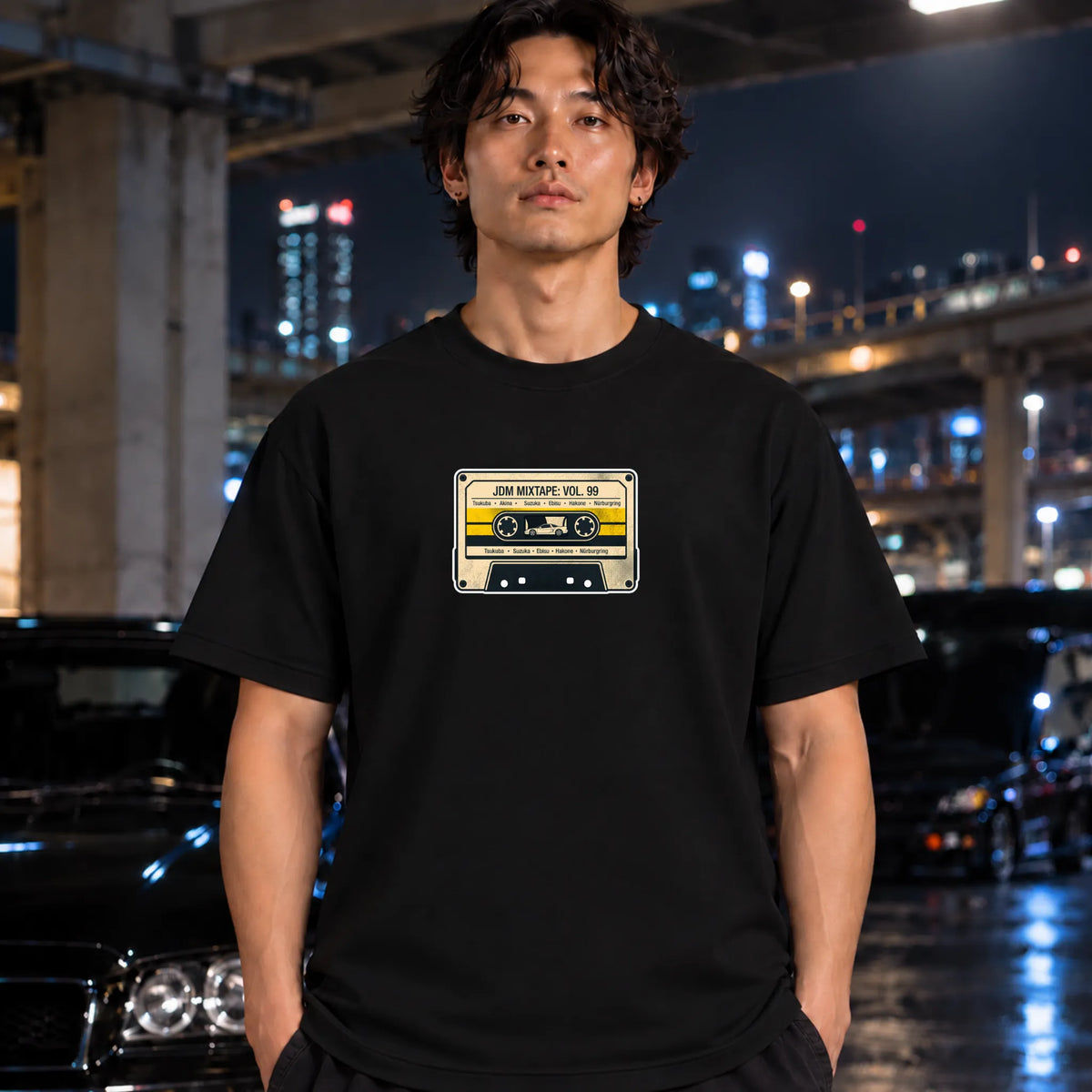 black crewneck t-shirt worn by a man, featuring a retro cassette tape graphic on the chest with the text 'JDM MIXTAPE VOL.
