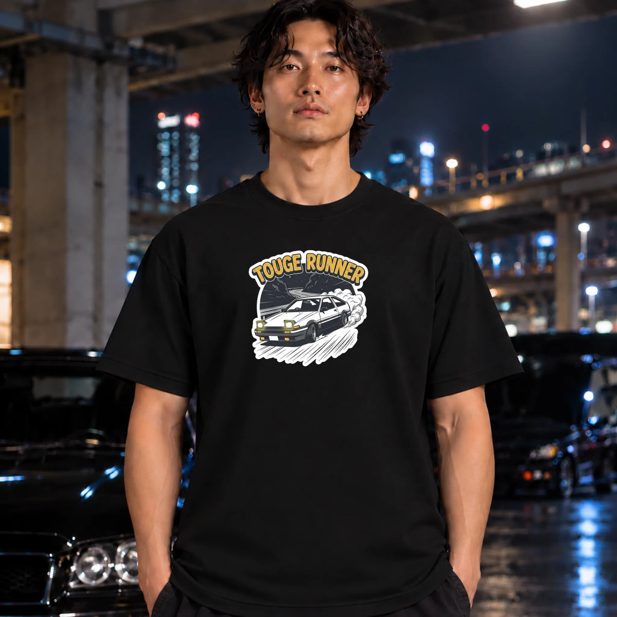 black short-sleeve t-shirt with a 'TOUGE RUNNER' graphic featuring a black car and yellow text, worn by a man