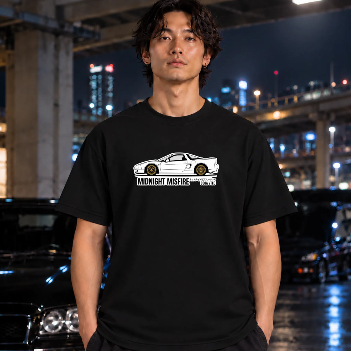 black short-sleeve t-shirt worn by a man, featuring a white sports car graphic and the text 'MIDNIGHT MISFIRE '