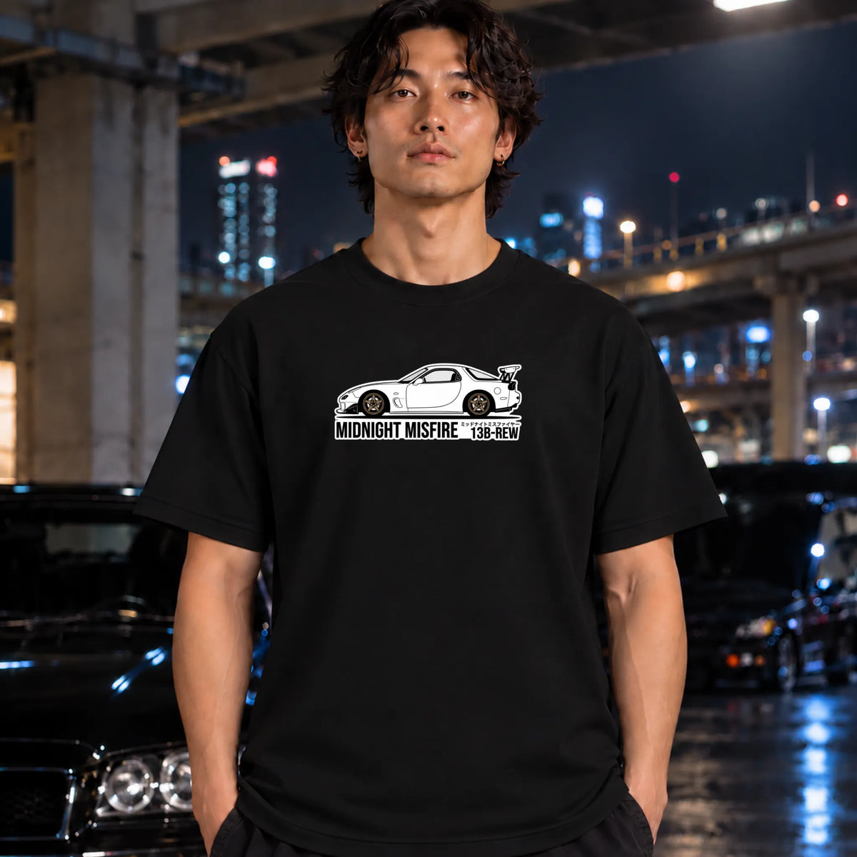 black short-sleeve t-shirt worn by a man, featuring a white sports car graphic and the text 'MIDNIGHT MISFIRE '
